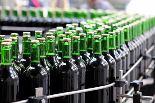 beer bottles are on an assembly line